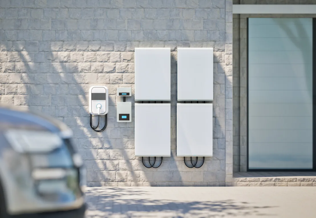 Two home battery units mounted on an exterior brick wall