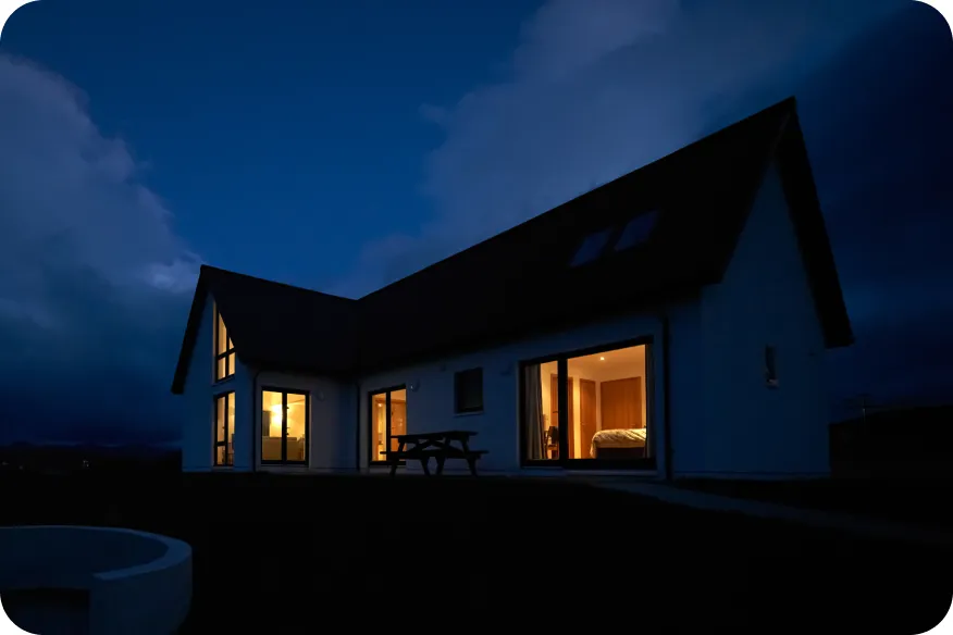 Home with its lights on at night