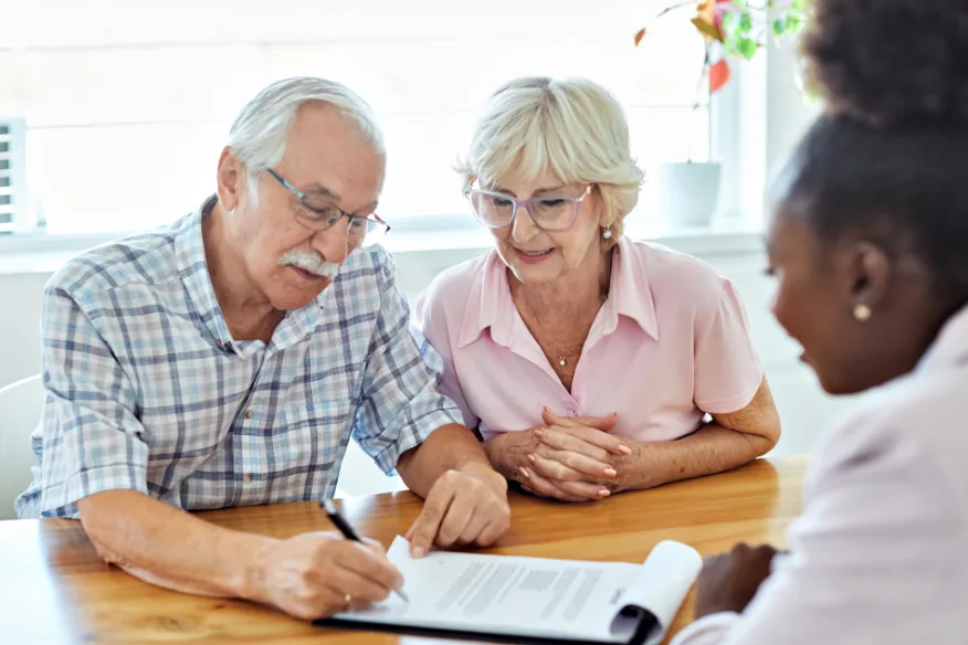 Older couple reviewing paperwork at a table