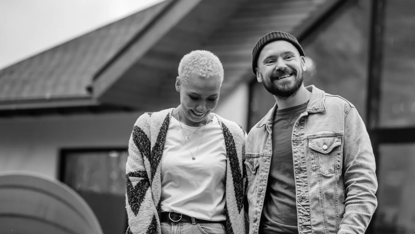 Smiling couple standing together outdoors